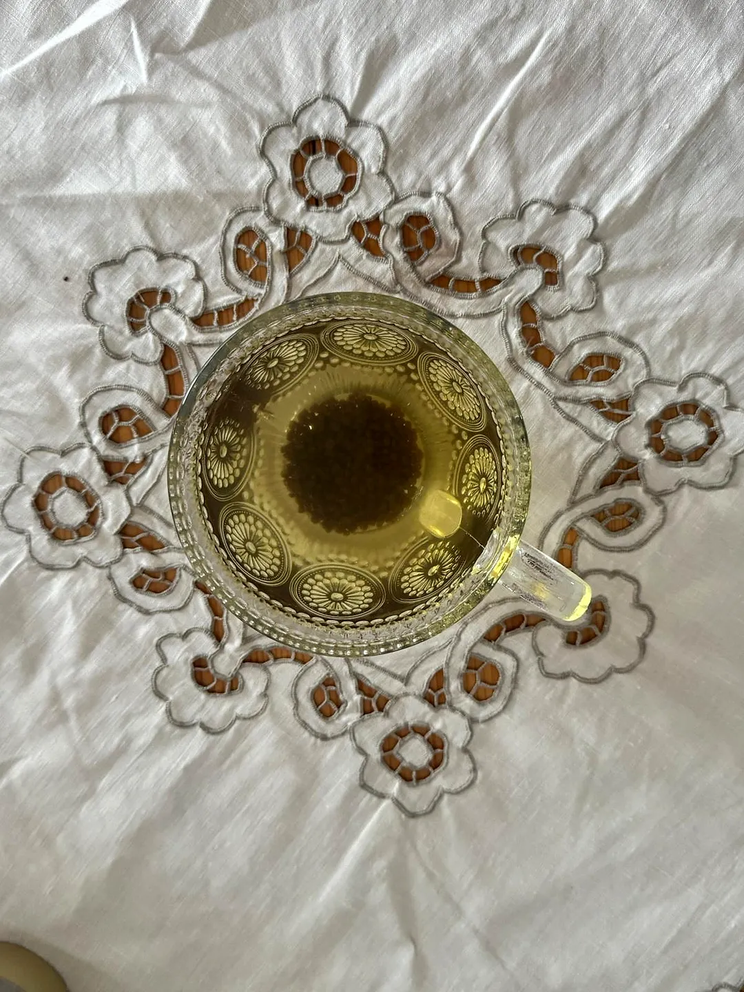Top view of golden tartary buckwheat tea in an ornate glass cup